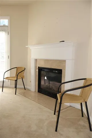 a living room with a chair and a fireplace