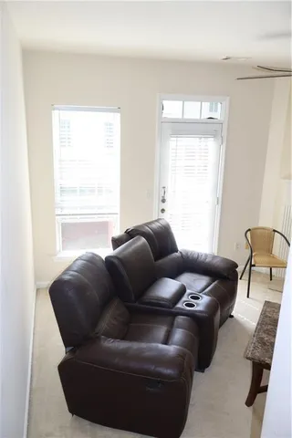 a view of a livingroom with wooden floor and stairs