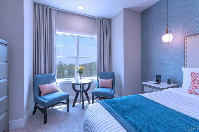 a bedroom with a bed and a chair