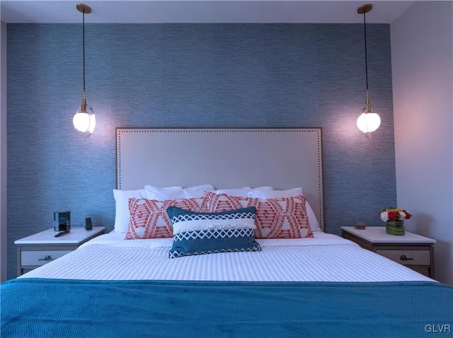 a bedroom with a bed and a potted plant