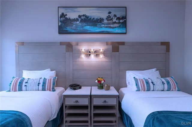 a bedroom with a bed and a painting on the wall