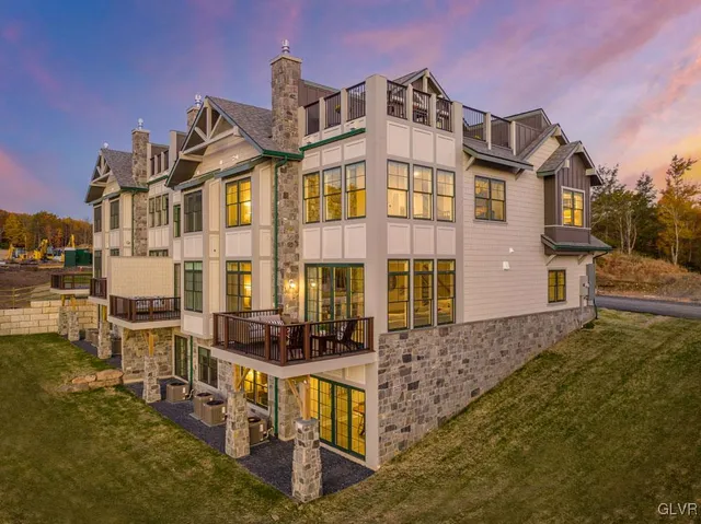 a front view of a residential apartment building with a yard