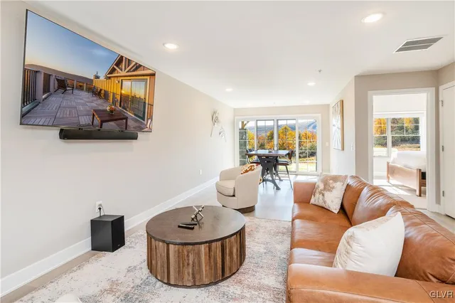 a living room with furniture and a large window
