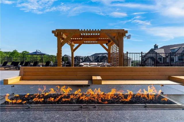a view of a terrace with a table and chairs under an umbrella