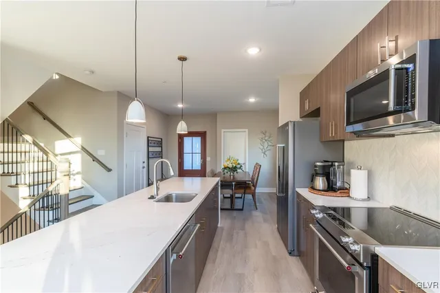 a kitchen with stainless steel appliances a stove sink microwave and cabinets