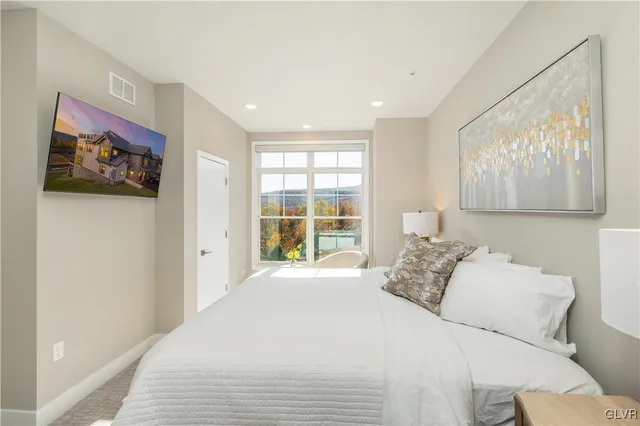 a bedroom with a large bed and a window