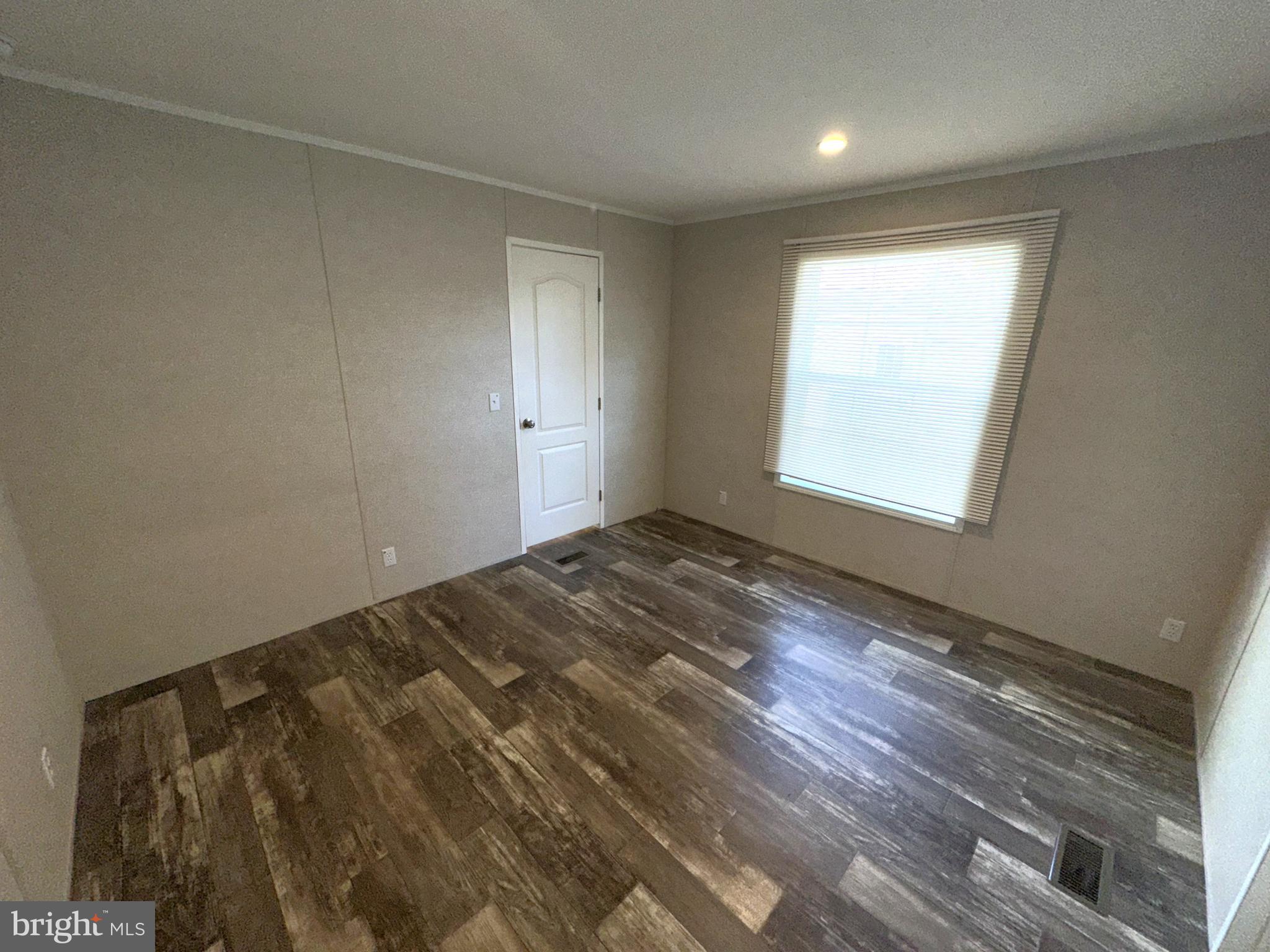 490 North Patuxent Road, Unit 21 Odenton, MD 21113 - Photo 11 of 22 an empty room with wooden floor and windows