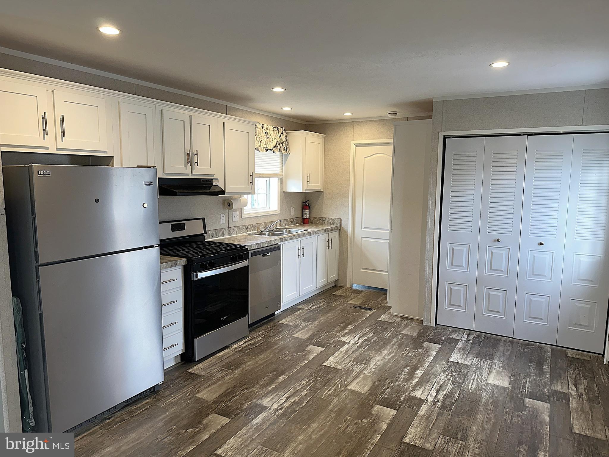 490 North Patuxent Road, Unit 21 Odenton, MD 21113 - Photo 3 of 22 a kitchen with stainless steel appliances granite countertop a refrigerator sink and cabinets