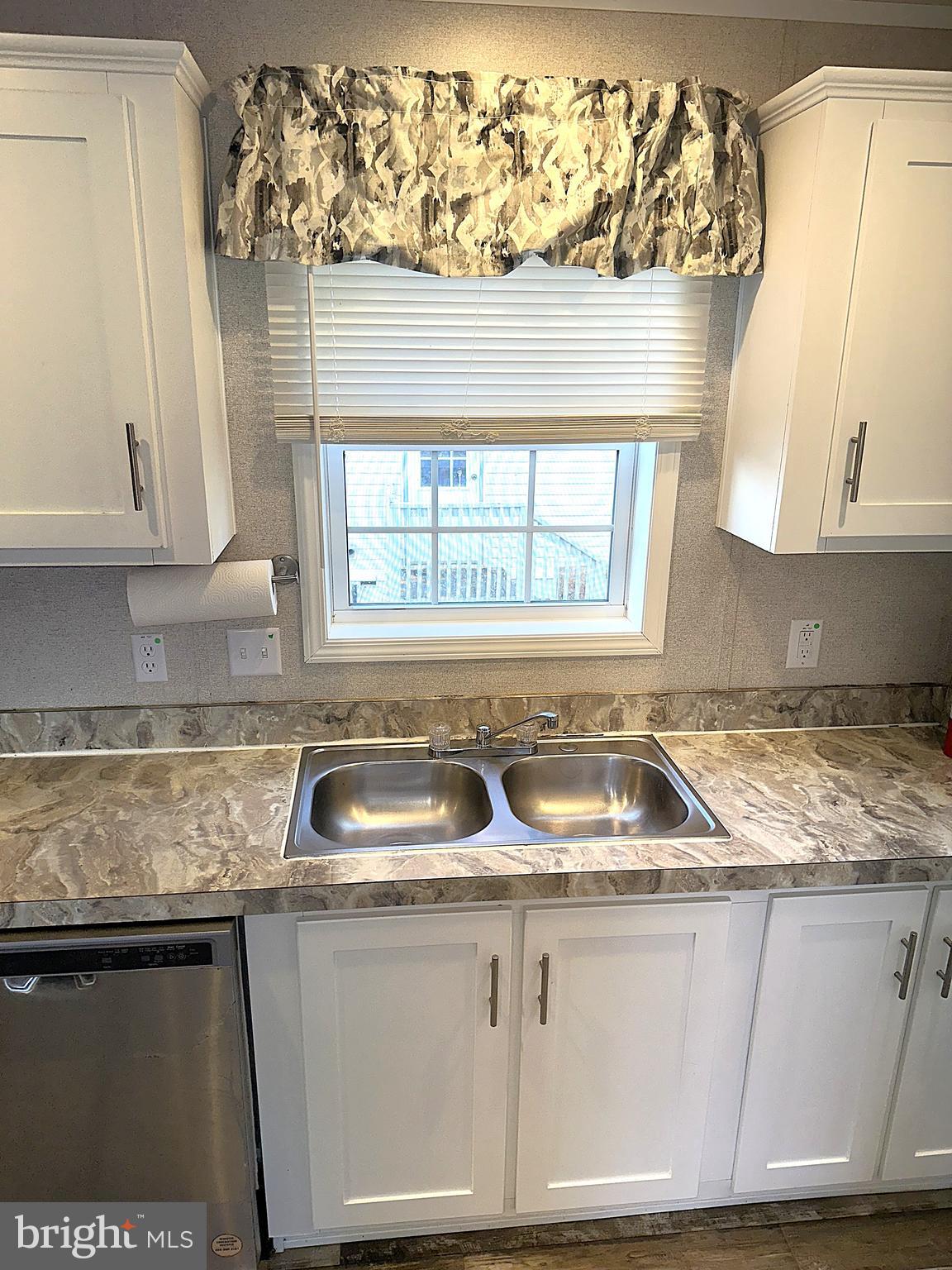 490 North Patuxent Road, Unit 21 Odenton, MD 21113 - Photo 5 of 22 a kitchen with granite countertop a sink window and cabinets