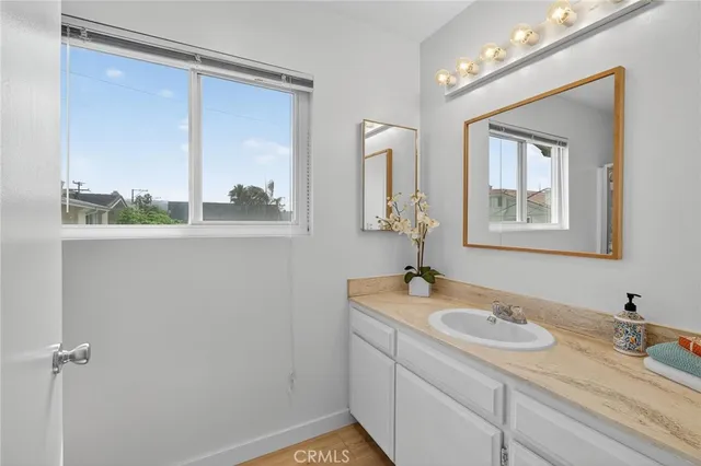 a bathroom with a granite countertop sink mirror and vanity