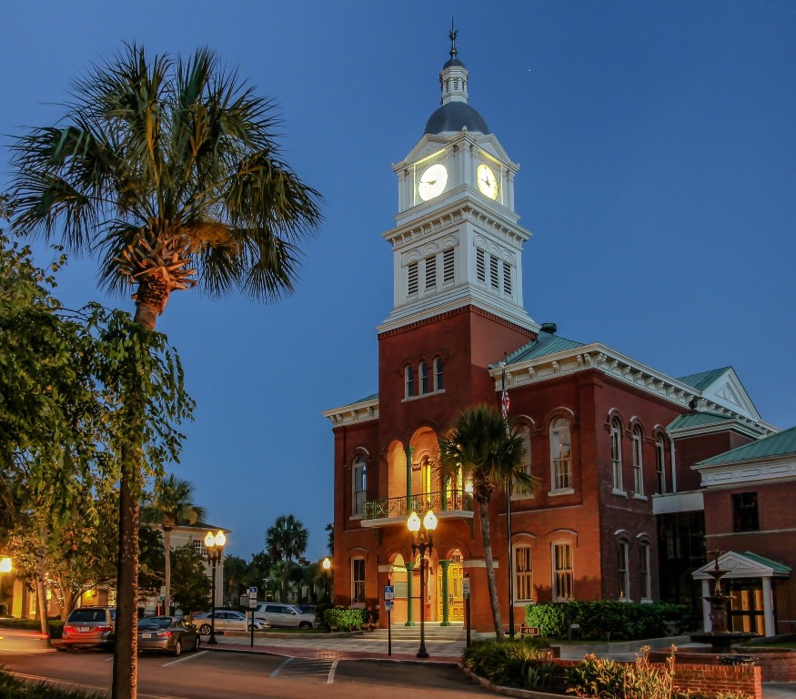 903 Someruelus Road Fernandina Beach, FL 32034 - Photo 20 of 24 a view of a building with a clock on the wall and a palm tree