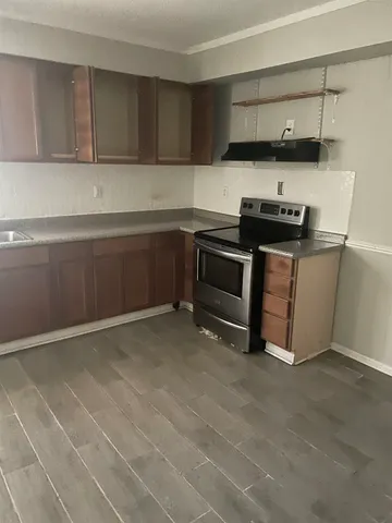 a kitchen with stainless steel appliances a stove and a refrigerator