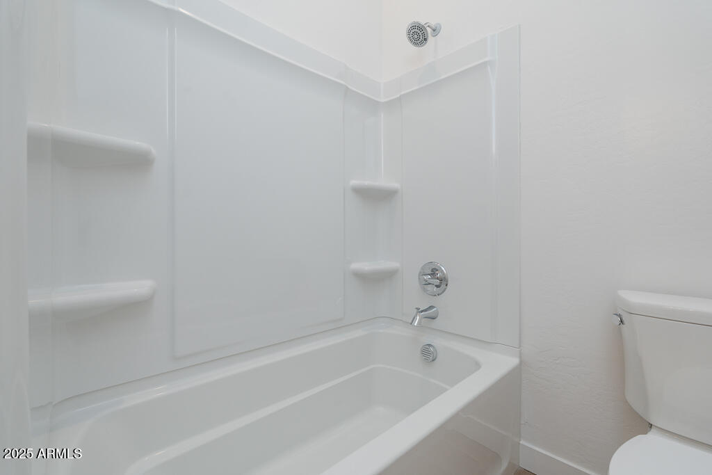 816 Golden Ore Pass Apache Junction, AZ 85120 - Photo 16 of 23 a white bath tub sitting next to a white toilet