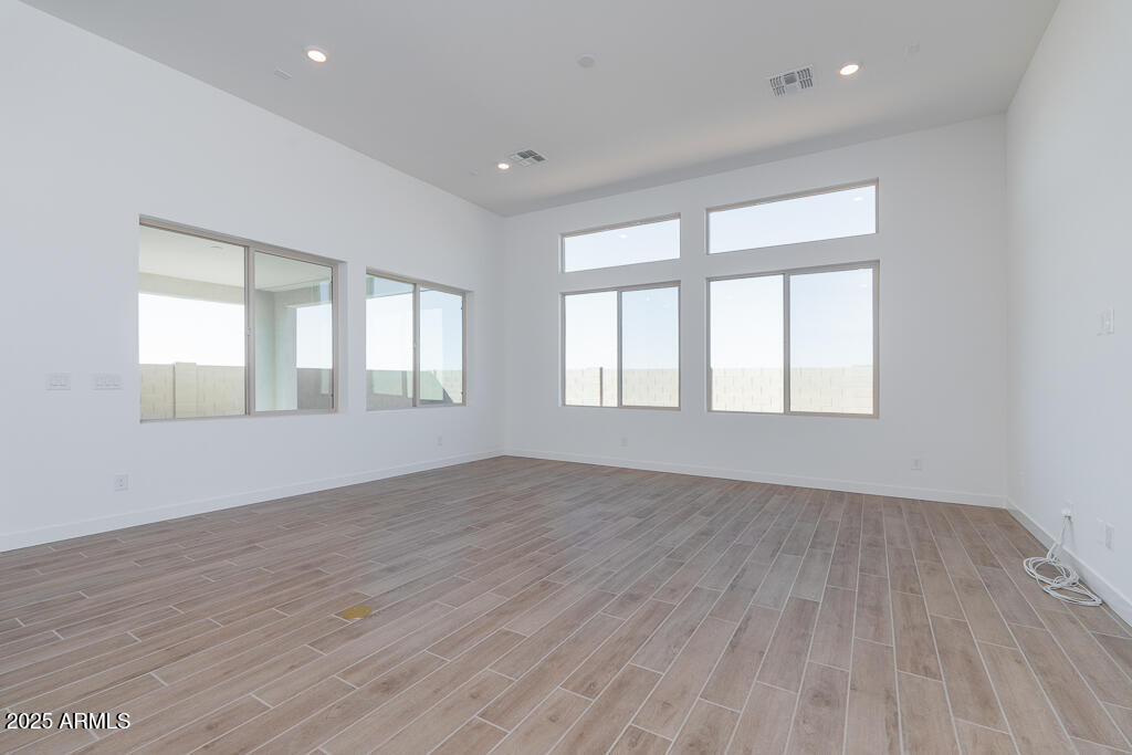 816 Golden Ore Pass Apache Junction, AZ 85120 - Photo 4 of 23 a view of an empty room with wooden floor and window