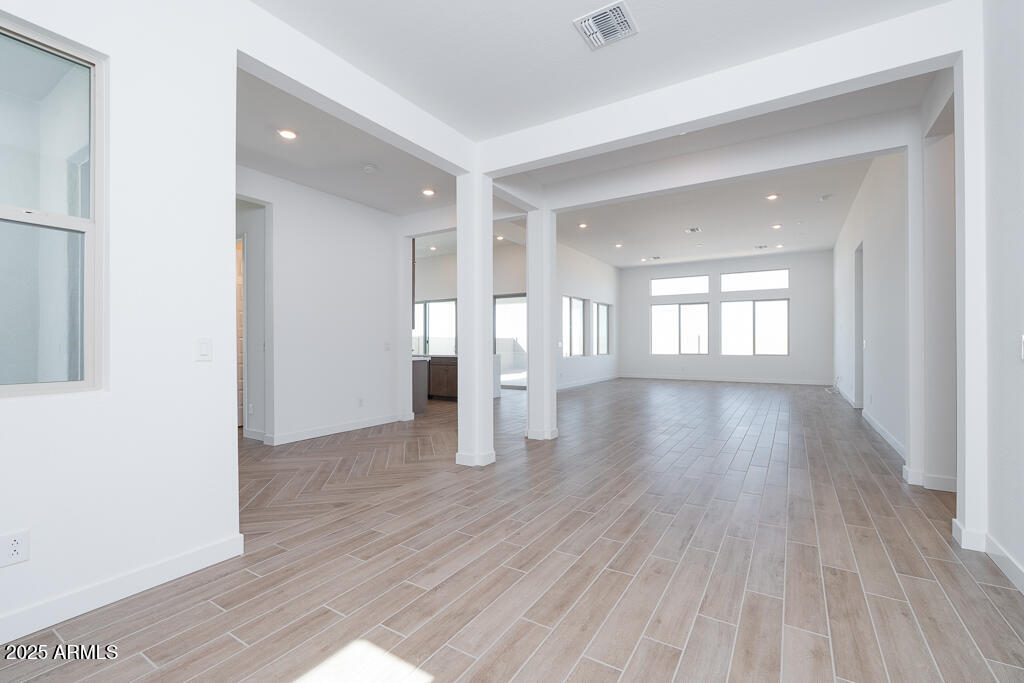 816 Golden Ore Pass Apache Junction, AZ 85120 - Photo 6 of 23 an empty room with wooden floor and windows