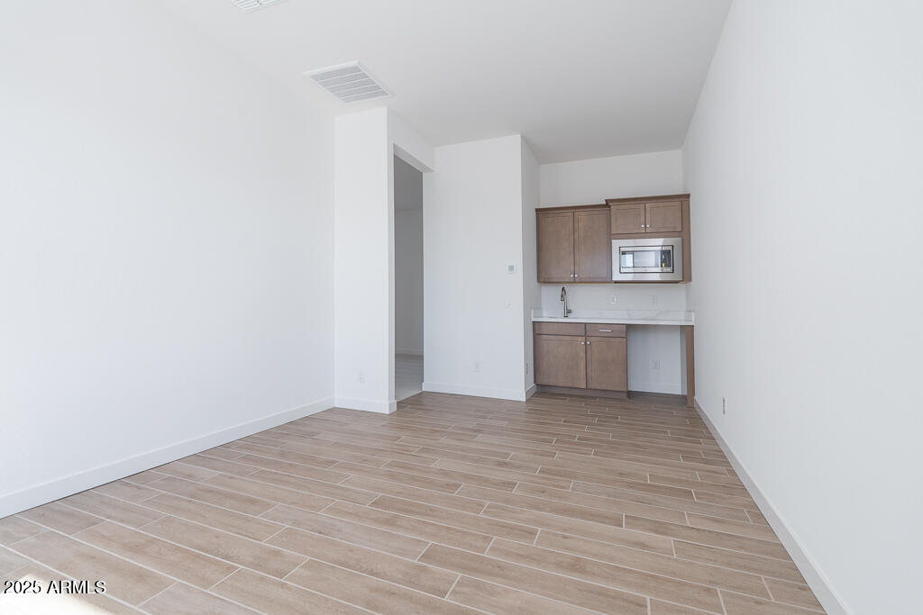 816 Golden Ore Pass Apache Junction, AZ 85120 - Photo 7 of 23 a view of a kitchen with wooden floor and a sink