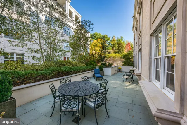 a view of a patio with table and chairs and potted plants