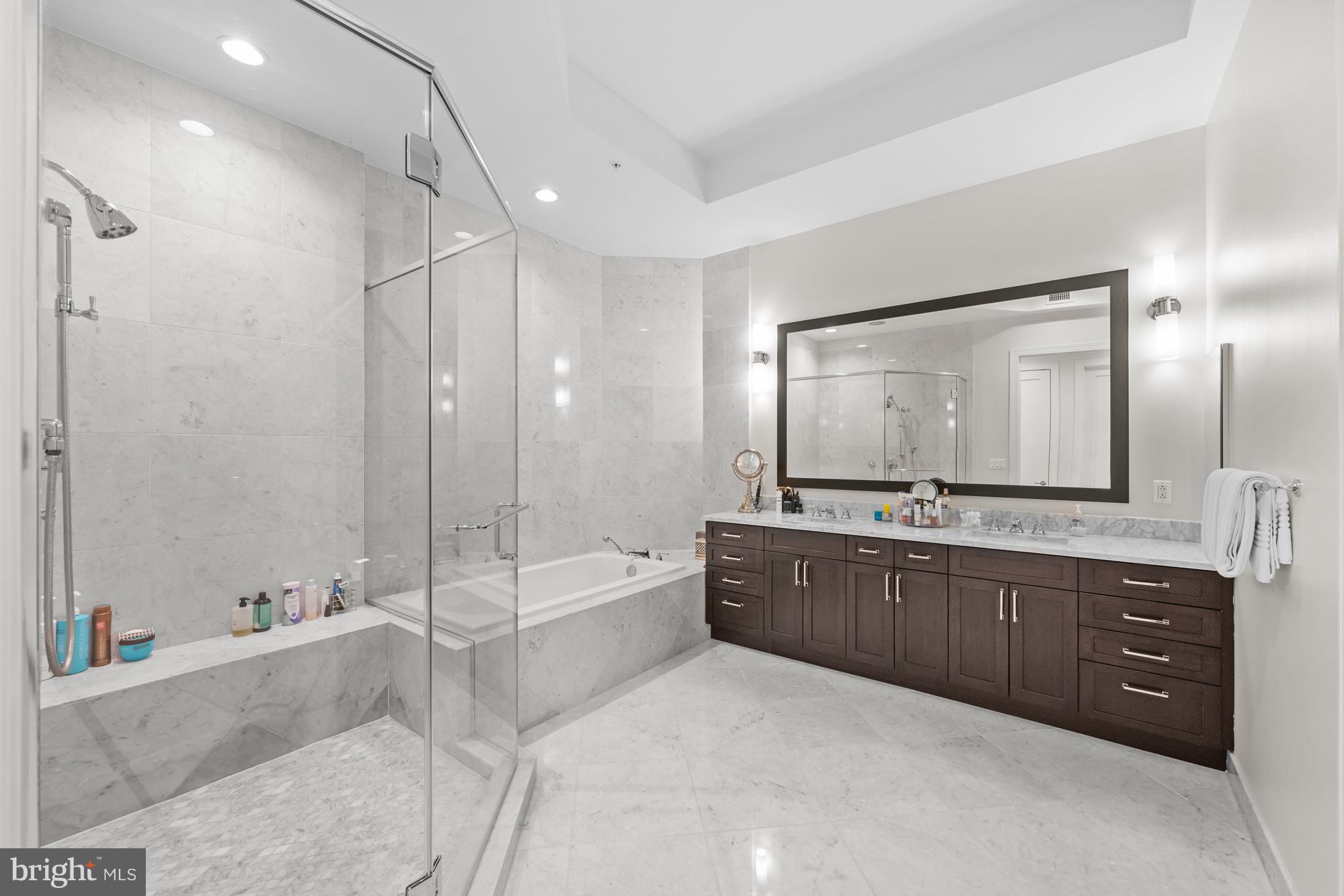 8111 River Road, Unit 116 Bethesda, MD 20817 - Photo 17 of 21 a spacious bathroom with a tub sink shower and mirror