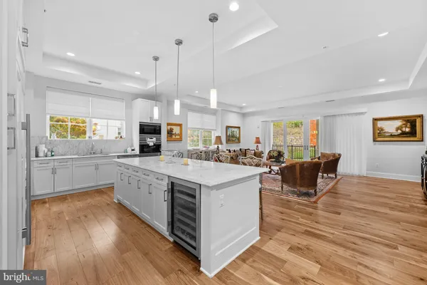 a open kitchen with stainless steel appliances granite countertop a stove and a wooden floors