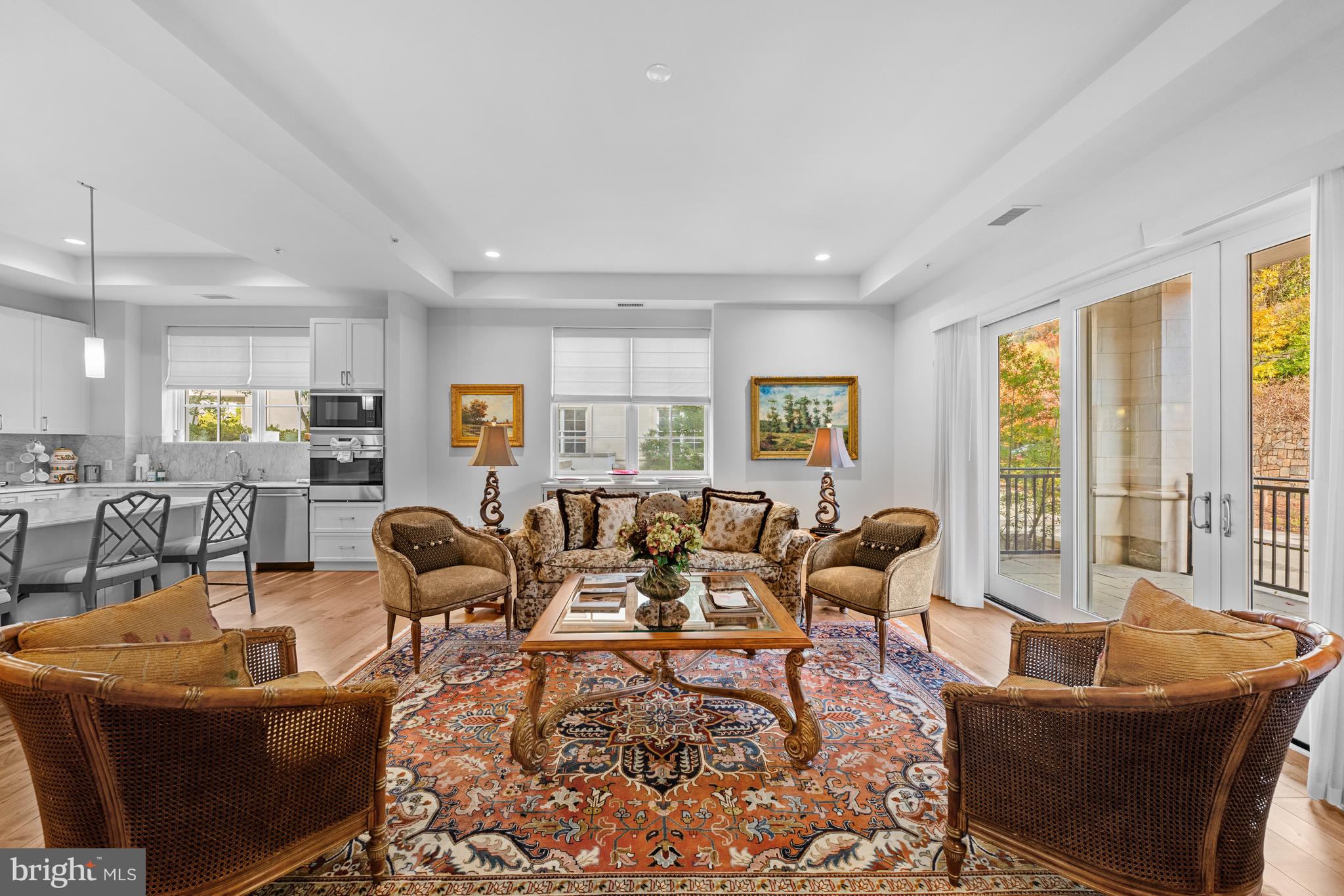 8111 River Road, Unit 116 Bethesda, MD 20817 - Photo 9 of 21 a living room with furniture large windows and wooden floor