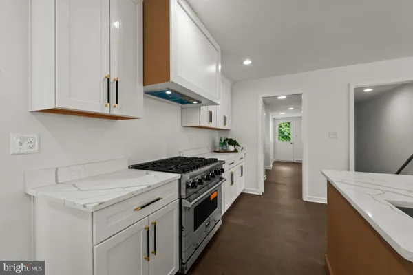 a kitchen with a stove and a white cabinets