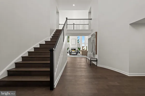 a view of entryway and hall with wooden floor