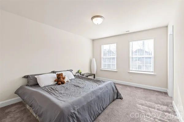 a bed sitting in a bedroom next to a window