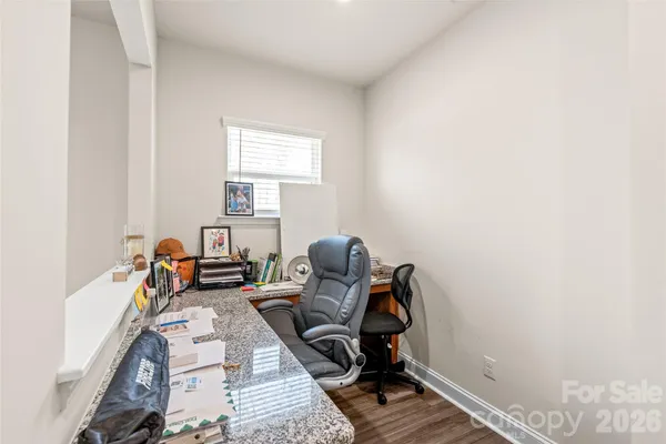 a view of a workspace with furniture and a window