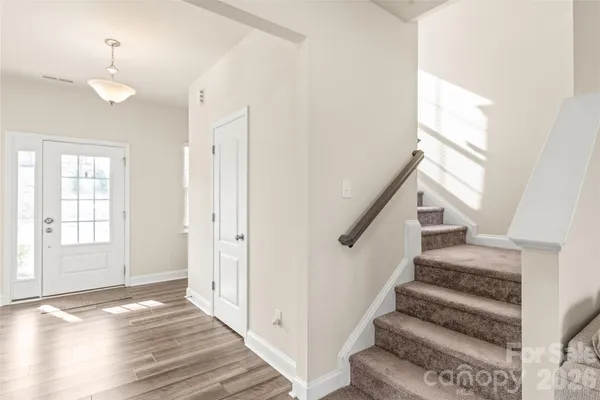 a view of entryway and hall with wooden floor