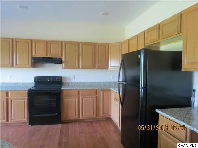 933 Mt Olivet Road Dyke, VA 22935 - Photo 2 of 28 a kitchen with a refrigerator and a stove top oven