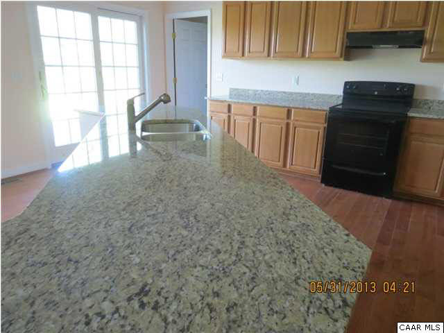 933 Mt Olivet Road Dyke, VA 22935 - Photo 10 of 28 a kitchen with granite countertop a stove a sink and a microwave