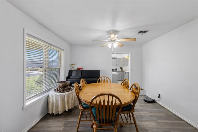 a view of a dining room with furniture and window