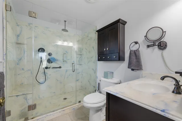 a bathroom with a sink toilet and shower
