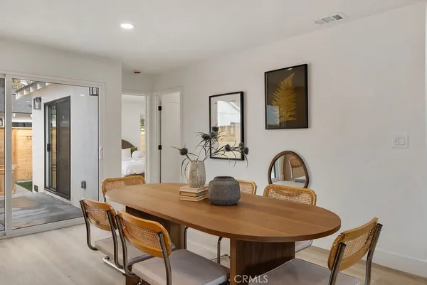 a dining room with furniture and wooden floor