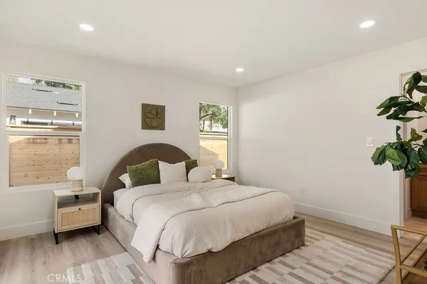 a bedroom with a bed and a potted plant