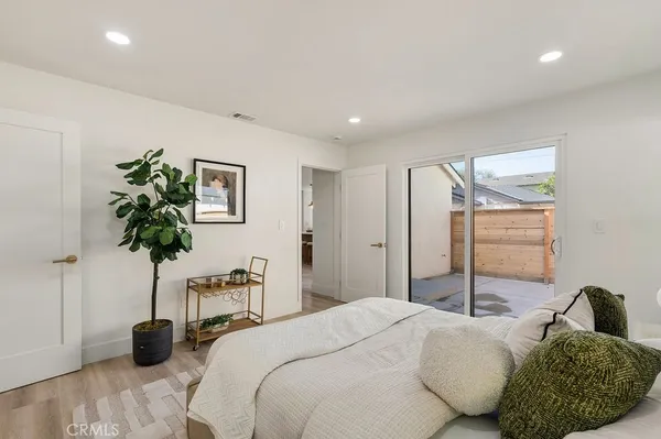 a bedroom with a bed and a potted plant