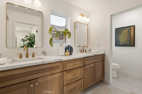 a bathroom with a double vanity sink and a mirror