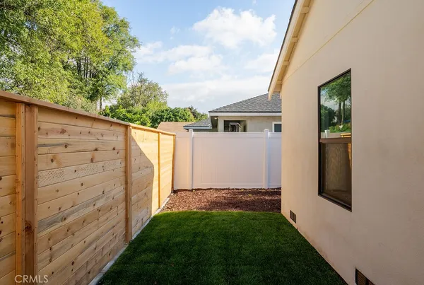 a view of house with backyard