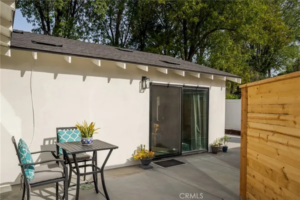a backyard of a house with table and chairs