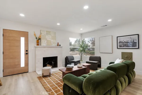 a living room with furniture and a fireplace