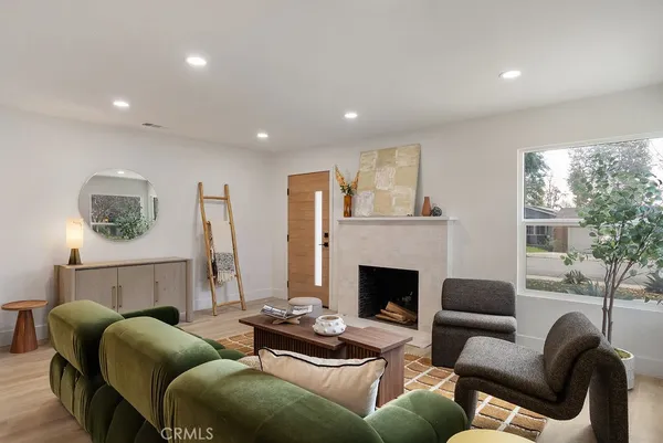 a living room with furniture and a fireplace