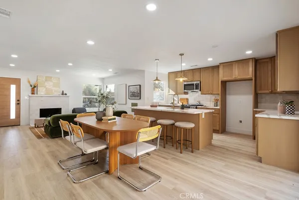 a large kitchen with a table and chairs