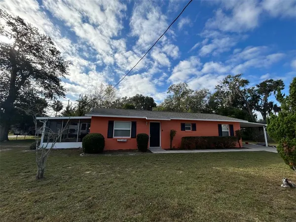 a view of house with backyard space and garden