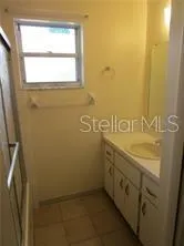 a bathroom with a sink and a window