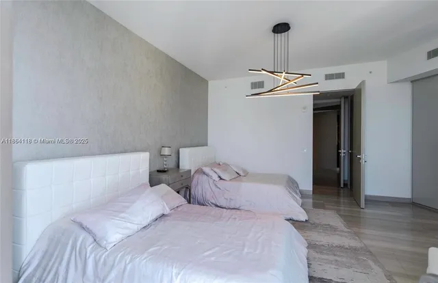 a bedroom with a bed and cabinets