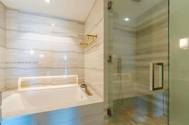 a bathroom with a bathtub and a shower