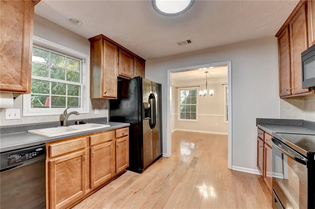 310 Andrew Ridge Drive Jefferson, GA 30549 - Photo 20 of 52 a kitchen with a sink a stove a refrigerator and a window