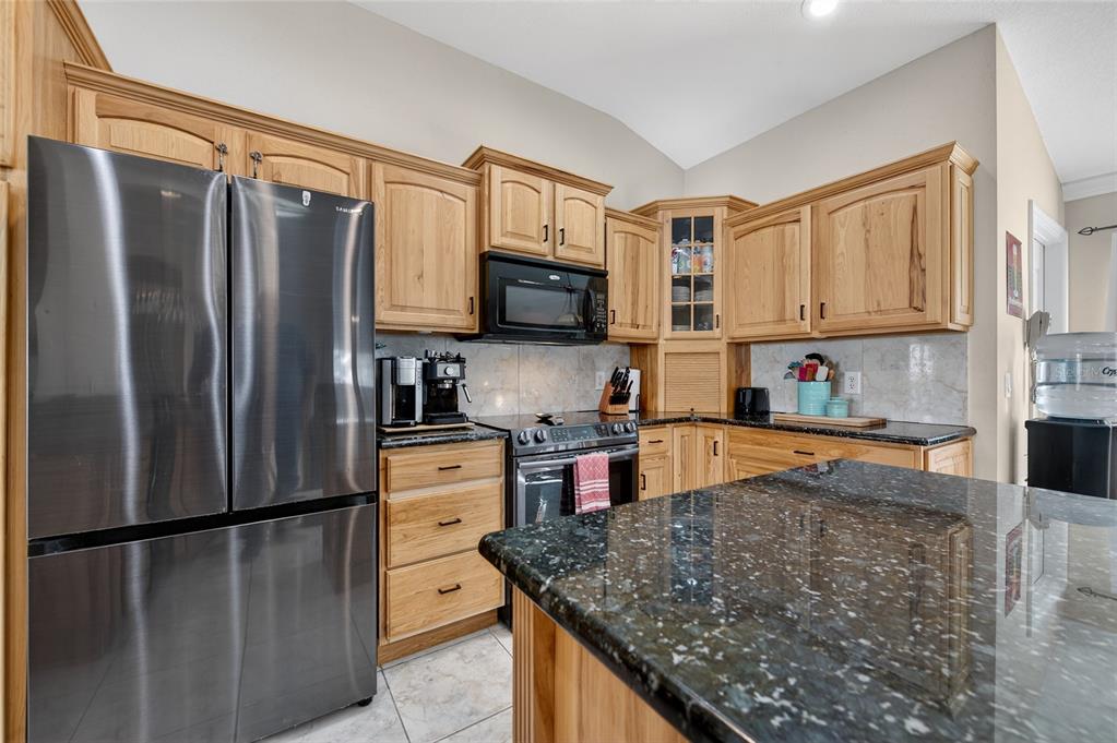 1864 Orange Tree Drive Edgewater, FL 32141 - Photo 12 of 38 a kitchen with stainless steel appliances granite countertop a refrigerator stove microwave and sink