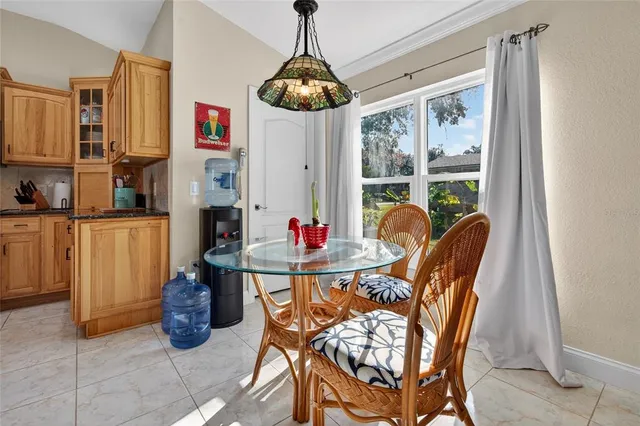 a view of a dining room with furniture large windows and wooden floor