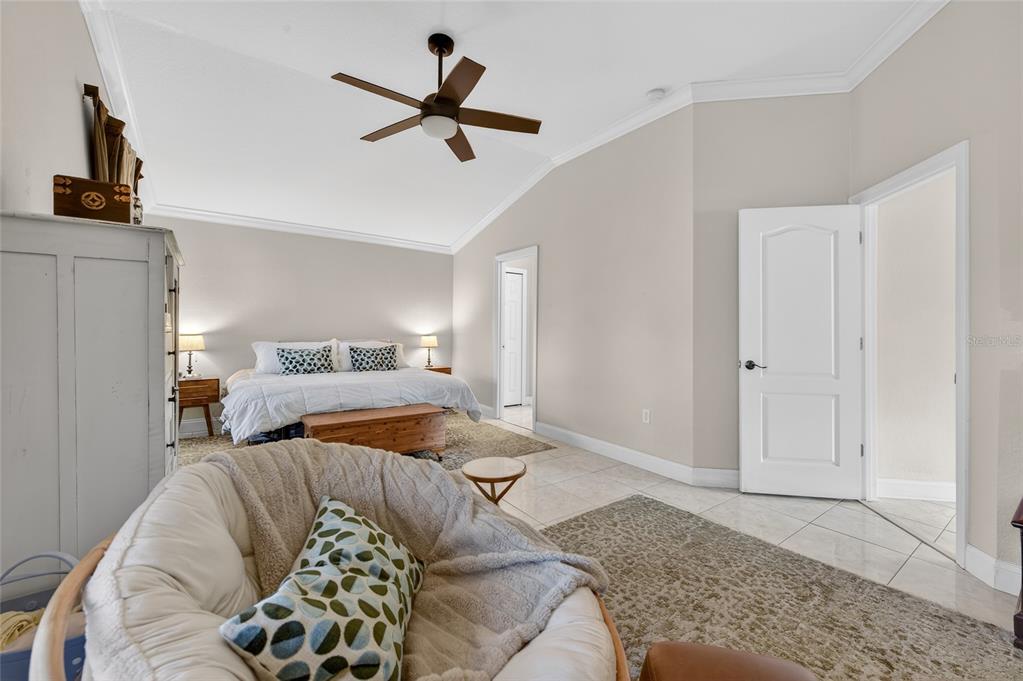 1864 Orange Tree Drive Edgewater, FL 32141 - Photo 23 of 38 a bed room with a bed a couch and a window